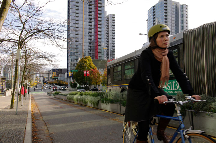 Woman using protected bike lane